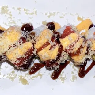 maki sushi roll with sauce and toppings