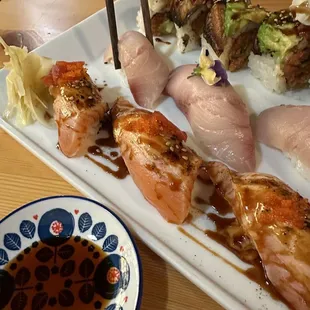 a plate of sushi with chopsticks
