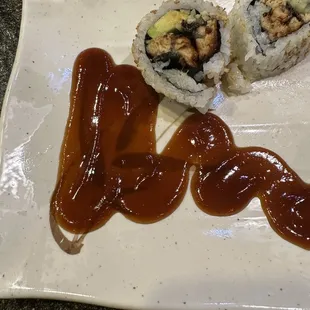 a plate of sushi and sauce