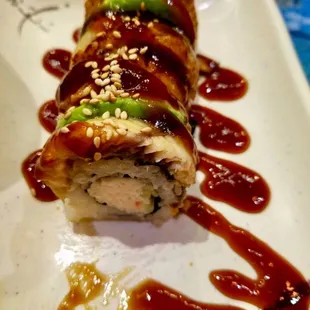 a close up of a roll with sauce on it