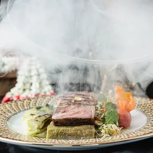 a plate of food with smoke coming out of it