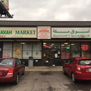 two cars parked in front of the store