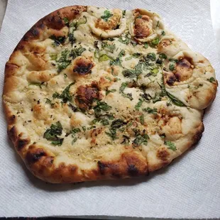 a flatbread pizza on a napkin