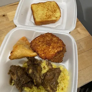 Breakfast platter: rice, lamb stew, hash brown, falafel, French toast, and sambusa