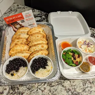 Family Meal to-go. 10 empanadas, 4 sides, 2 sauces. $28.50. I recommend it.