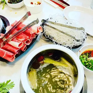 Broth is Mushroom Chicken (red date aka Jujube, sliced ginger and 2 sprigs of green onion)