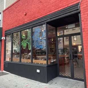 a red brick building with graffiti on the windows