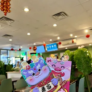a hand holding a chinese new year card