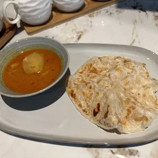 a plate of food and a bowl of soup