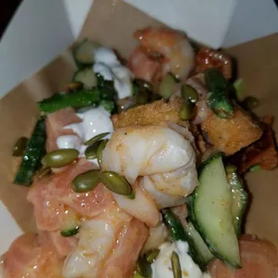 a shrimp salad in a paper container