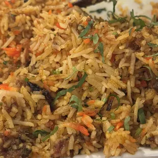 Goat biryani.  Delicious, cooked with whole spices and juicy bone in goat pieces.