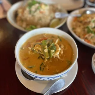 a bowl of soup and a plate of rice