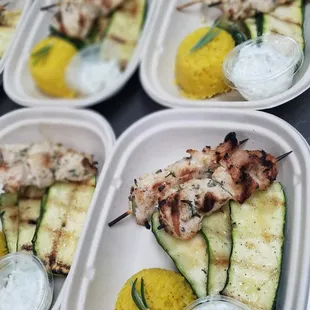 Lemon rosemary chicken skewers with yellow rice, grilled zucchini and home-made tzatziki sauce. Healthy meal prep ready to eat when you are!