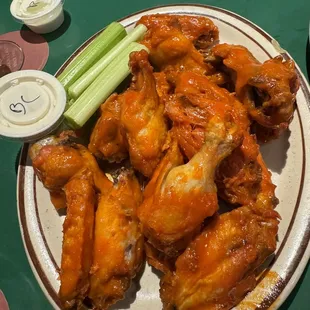 a plate of wings and celery