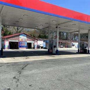 a gas station with a red roof