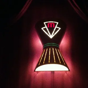 New lights illuminate freshly redecorated, plush theatre seating.