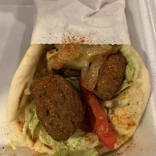 a pita with meatballs and lettuce