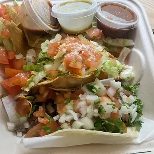 Can&apos;t see it, but SO much meat! Carne Asada Taco up front, Shredded Beef hard Taco in middle, chicken tamal at back.