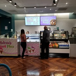 two people standing in front of the counter