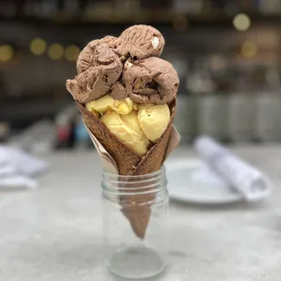 Peach Passion Fruit &amp; Rocky Road in a waffle cone
