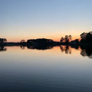 a calm lake at sunset