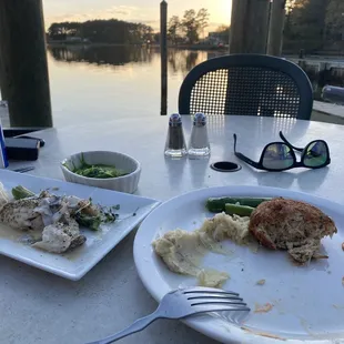 Our view next to water outside. Sea Bass "Catch of the Day" on the left, crab cake on right. Both amazing!