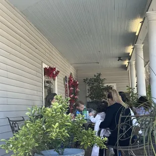 a group of people sitting on a porch