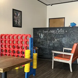 a game room with a chalkboard