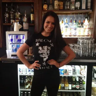 a woman standing in front of a bar