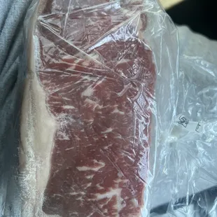 a piece of meat wrapped in plastic