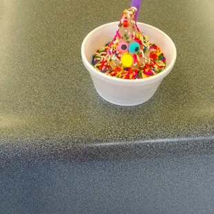 a bowl of sprinkles and a spoon