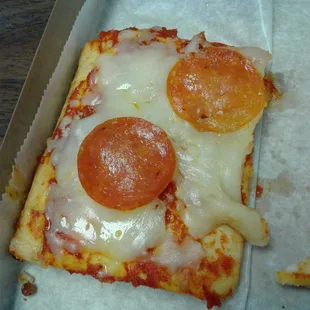 a slice of pizza in a box
