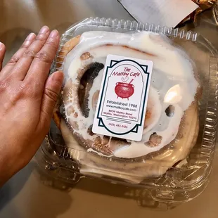 Cinnamon roll that fills up a large take out container.