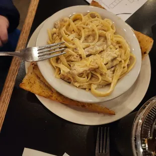 Kids chicken fettuccine with garlic bread.