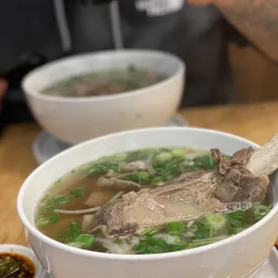 a bowl of soup with meat and vegetables