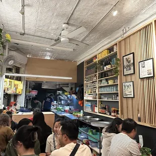 a group of people sitting at tables in a restaurant