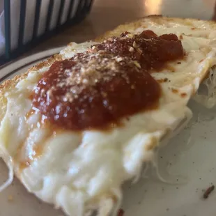 Close up of the juiciest garlic cheese bread around