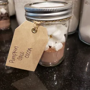 a mason jar filled with hot chocolate and marshmallows