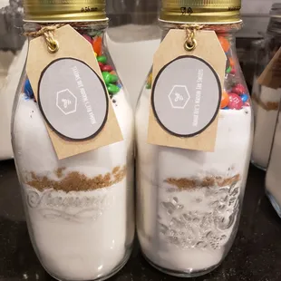 two mason jars filled with milk and candy