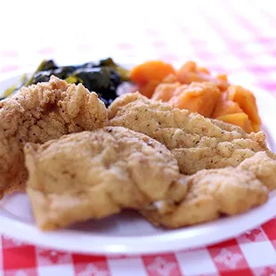 a plate of fried chicken and vegetables