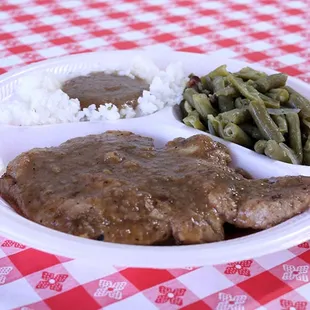 a plate of meat and green beans