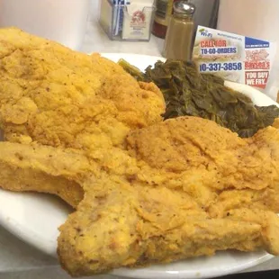 a plate of fried chicken and greens