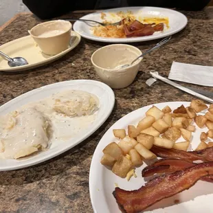 Eggs,bacon and home fries with biscuit and gravy.