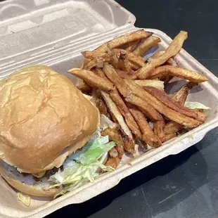 The kids cheeseburger with fries and added lettuce, charred onions, pickles and tomatoes.