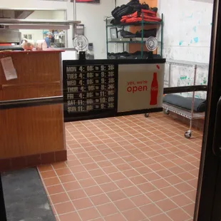 Hours of operation, front entry door.