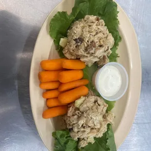 a plate of food with carrots and lettuce
