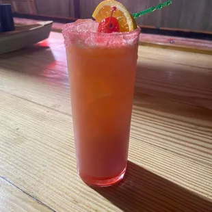 a pink drink with a cherry garnish