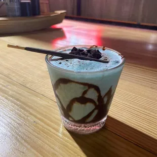 a glass of milkshake on a table