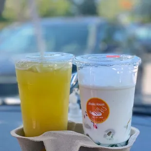 two cups of juice and a carton of yogurt
