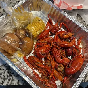 a tray of craws and corn